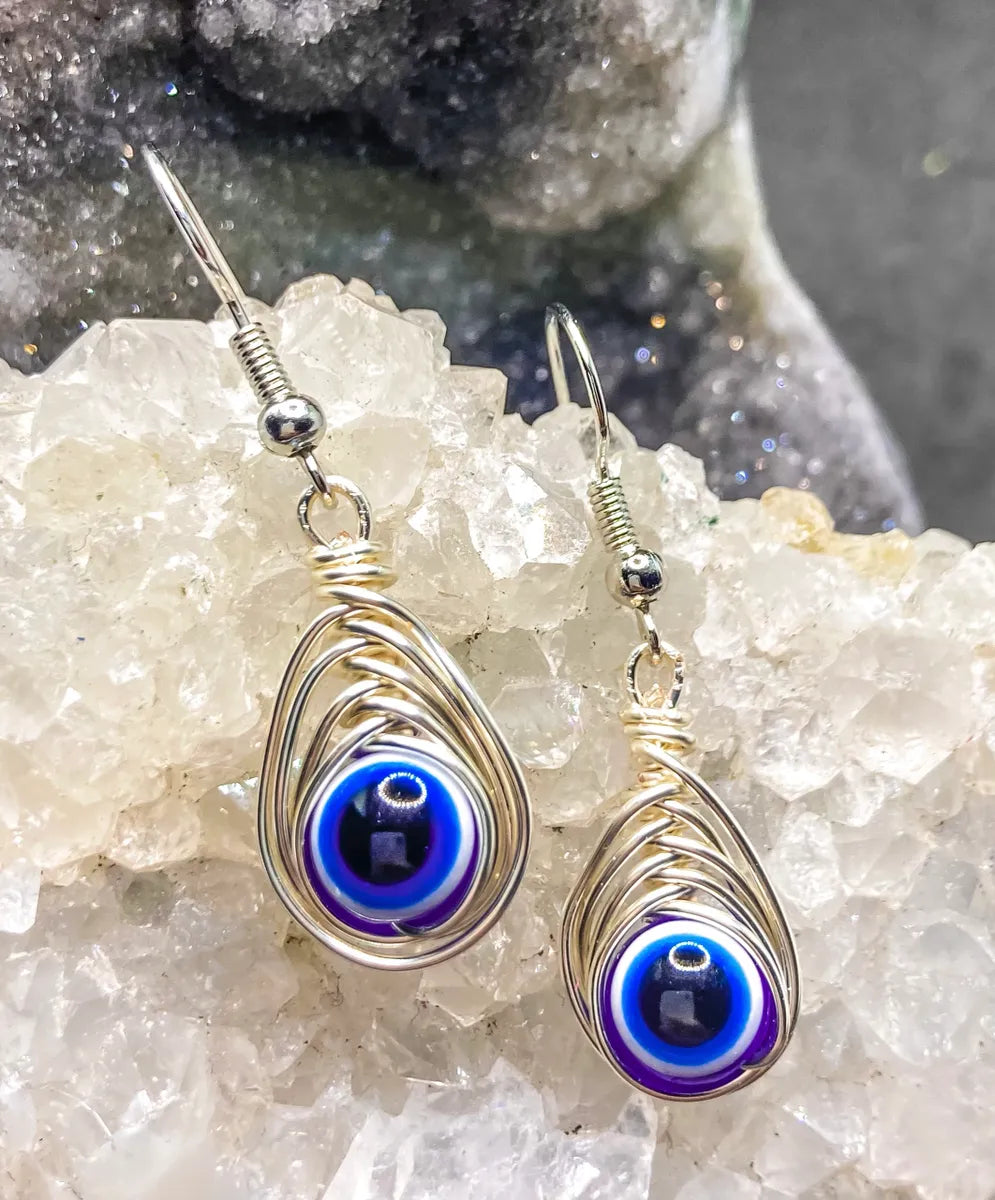 Evil eye wrapped in silver Earrings